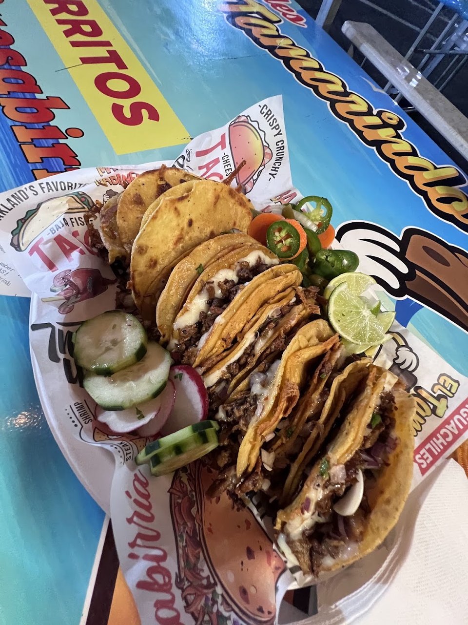 Restaurant menu showing birria, nachos, and burritos.