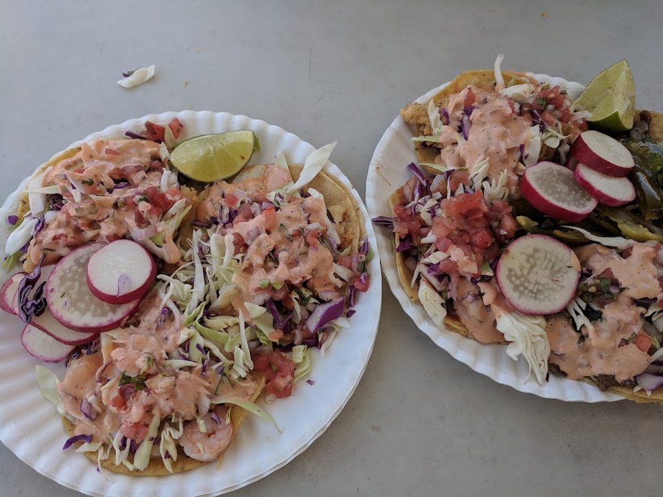 Printed menu with aguachiles, burritos, and tacos.